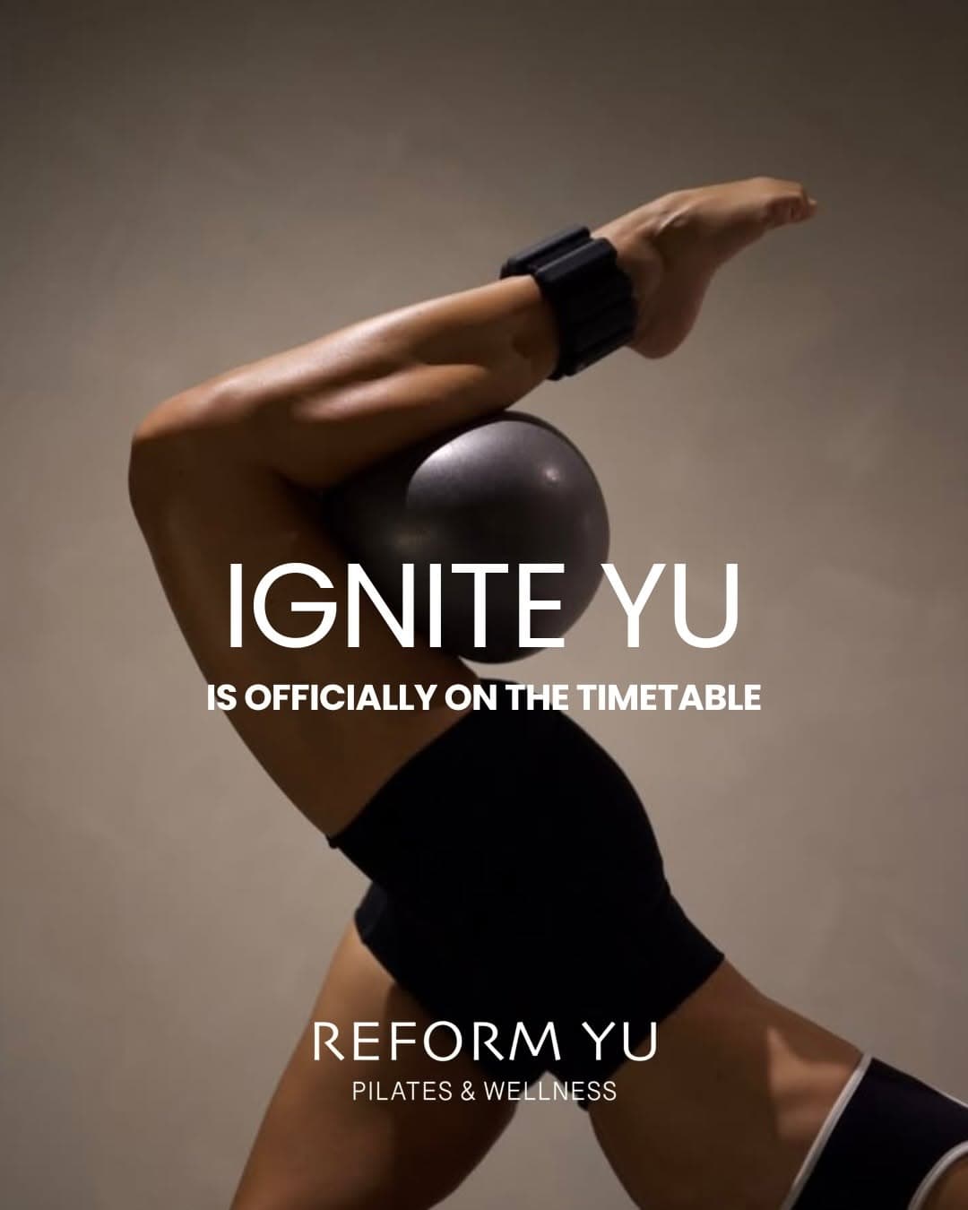 Ignite YU — woman with ankle weights and Pilates ball